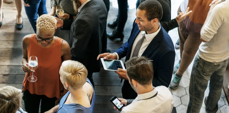 People mingling at a networking event. People mingling at a networking event.
