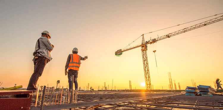 Two construction workers surveying a job site Two construction workers surveying a job site