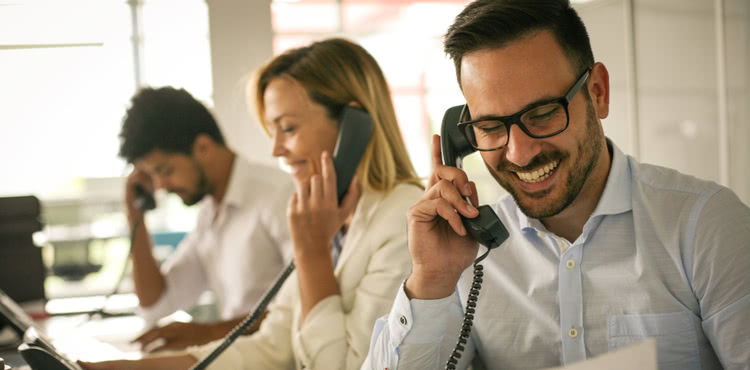 Three cheerful people talking on the phone. Three cheerful people talking on the phone.