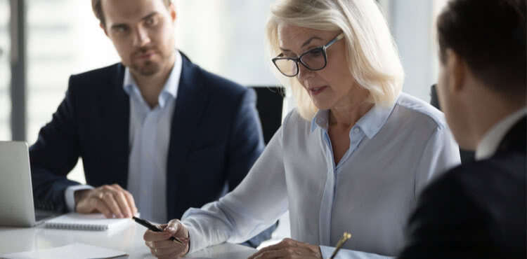 A serious woman signing paperwork A serious woman signing paperwork