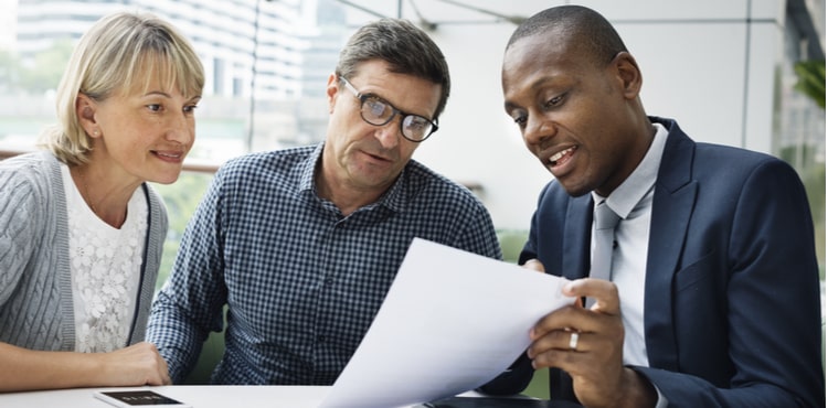 Insurance agent discussing bonds with customers Insurance agent discussing bonds with customers