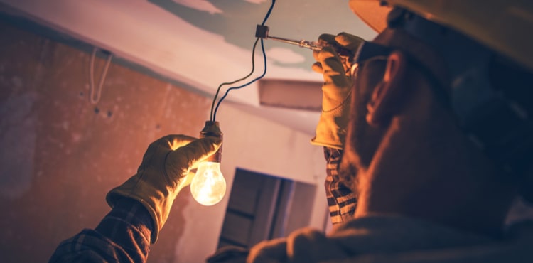 Electrician fixing light bulb wiring