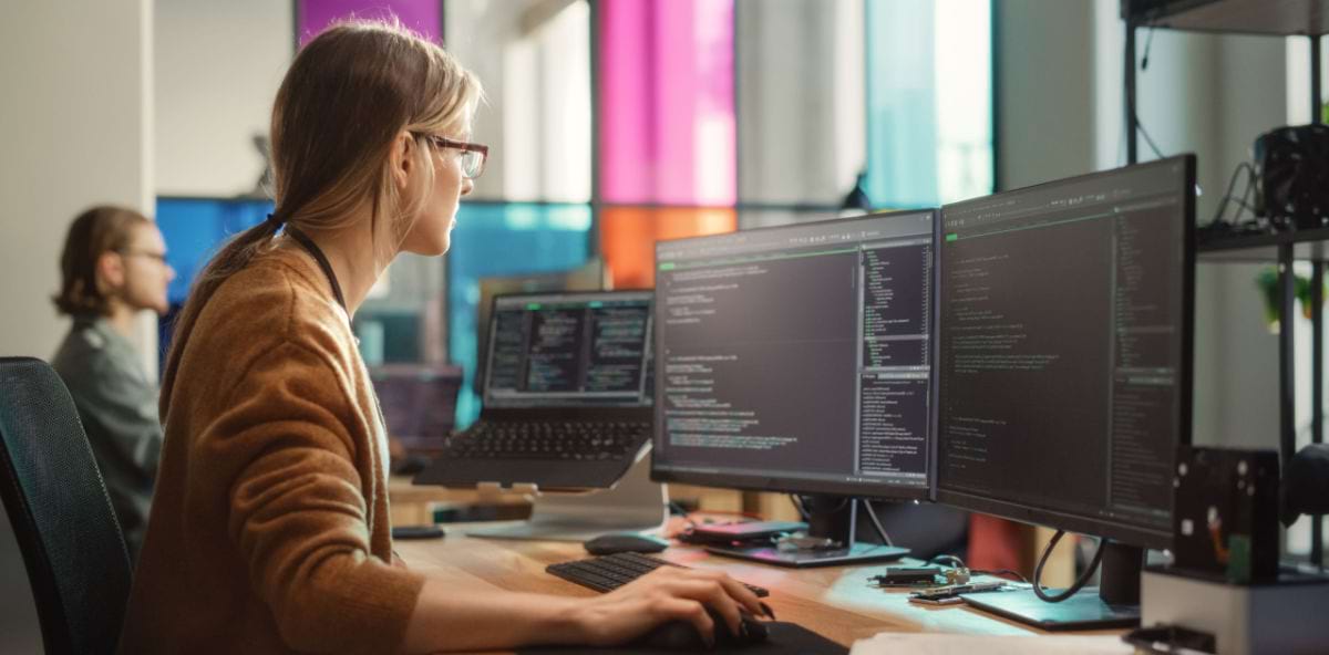 Software designer writing code for her development company Software designer writing code for her development company