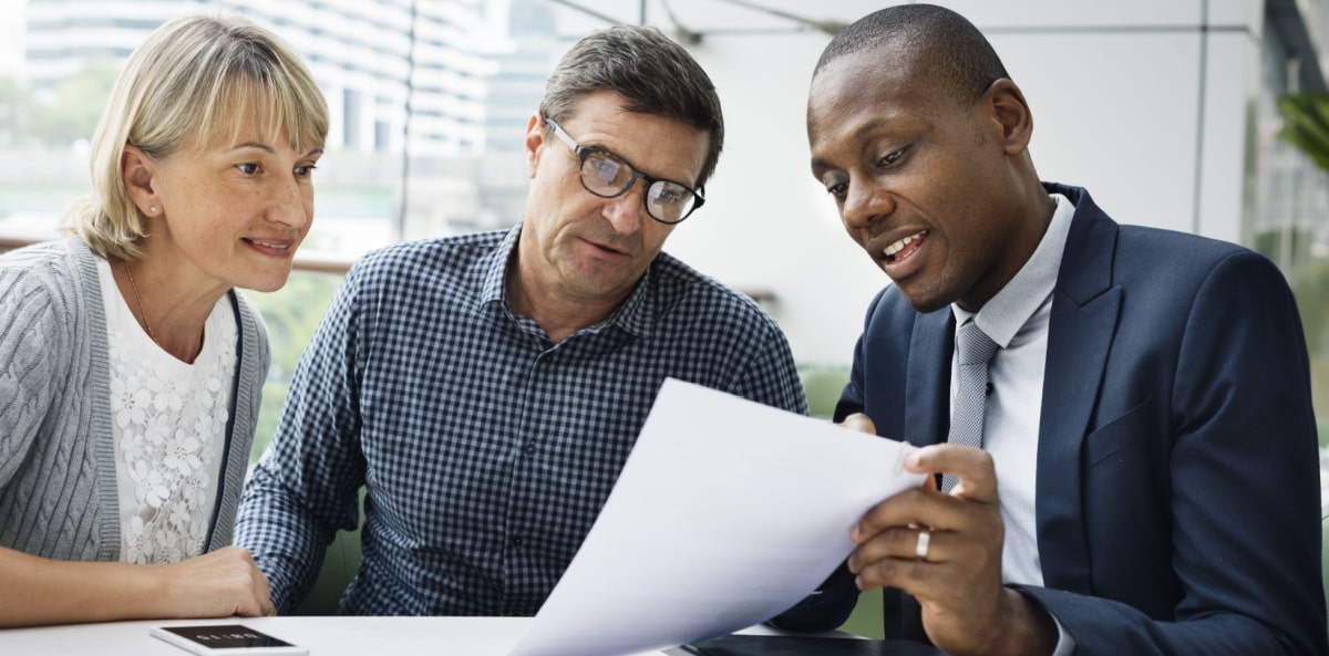 Insurance agent discussing licenses with customers Insurance agent discussing licenses with customers