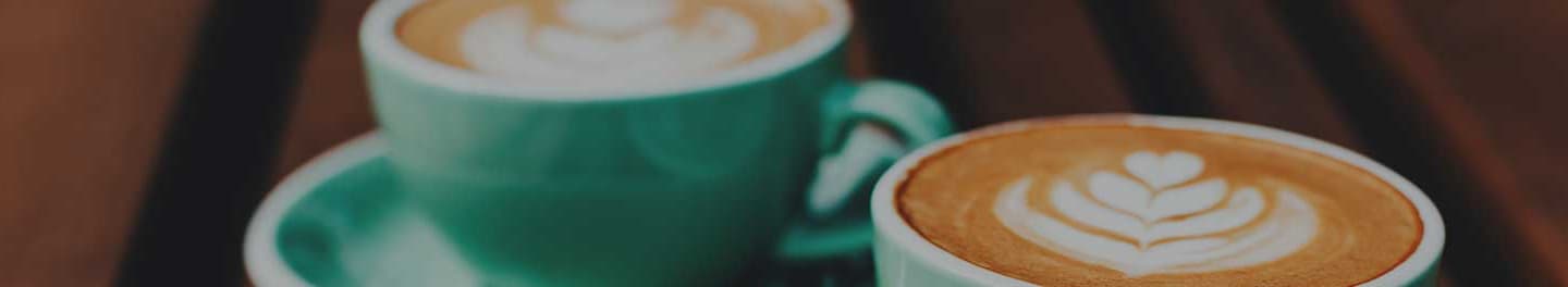 Two freshly made lattes. Two freshly made lattes.