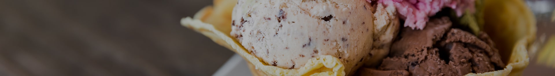 Several flavors of ice cream in a cone.