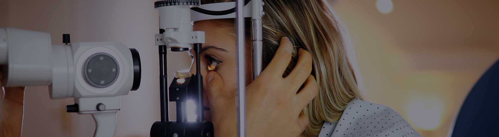 Optometrist checking patient eyesight and vision correction.