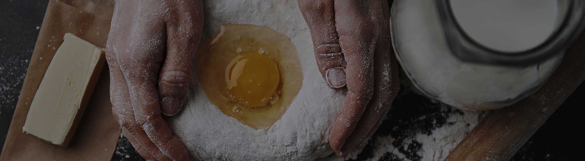 Hands cradling dough, preparing cookie dough.