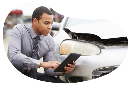 Insurance claims adjuster evaluating vehicle damage.