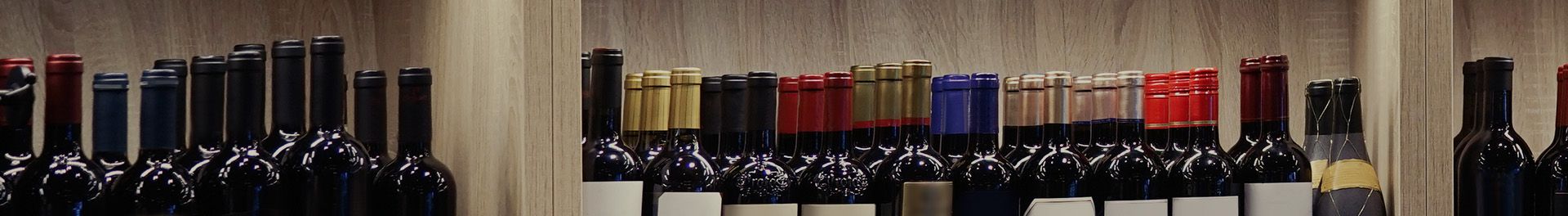 Assorted liquor bottles displayed on shelf.