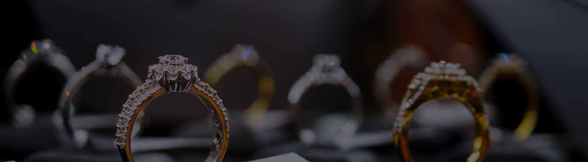 Diamond rings on display in a luxury retail store window.
