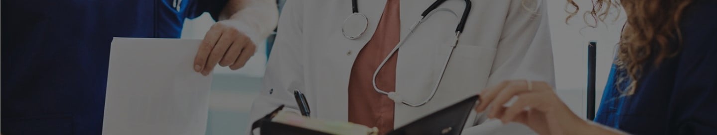 Health professionals reviewing patient files. Health professionals reviewing patient files.