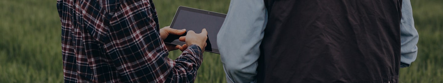Agricultural business owner and employee buying insurance from Nationwide on a tablet. Agricultural business owner and employee buying insurance from Nationwide on a tablet.