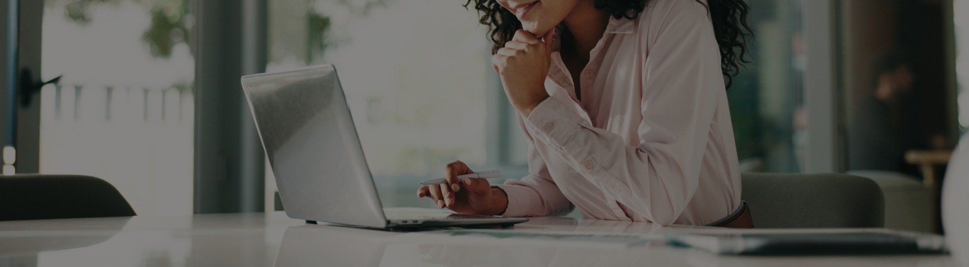 A small business owner reviews insurance quotes on their laptop. A small business owner reviews insurance quotes on their laptop.