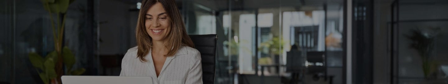 Blog author sitting with a laptop and writing about small business insurance.