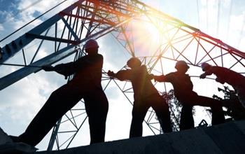 Silhouette of construction workers on a job site.
