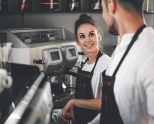 Two employees in a coffee shop.
