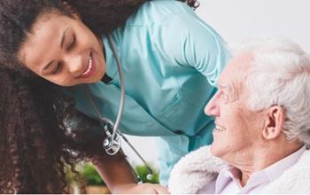 A female nurse caring for an elderly patient.