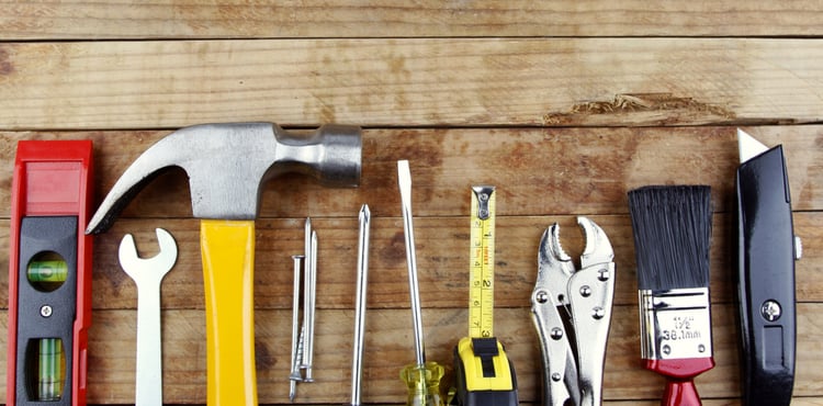 Tools lined up in a row on a wood background. Tools lined up in a row on a wood background.