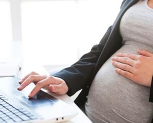 Pregnant woman at her desk.