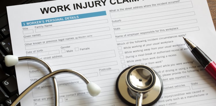 A work injury claim form and stethoscope.