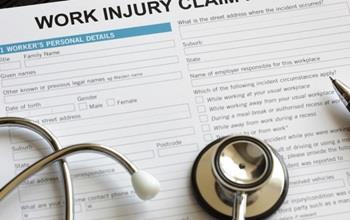 A work injury claim form and stethoscope.
