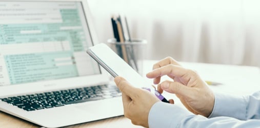 Calculating taxes while sitting at laptop.