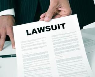 Man in suit hands over notice of lawsuit.