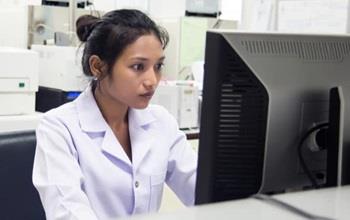 Nurse sitting at a computer.