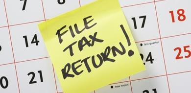 Post it reminder on calendar to file a tax return.