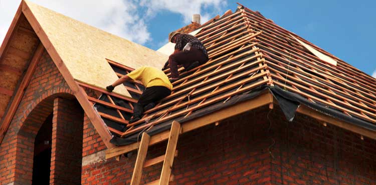 Contractors installing roofing.