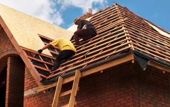 Contractors installing roofing.