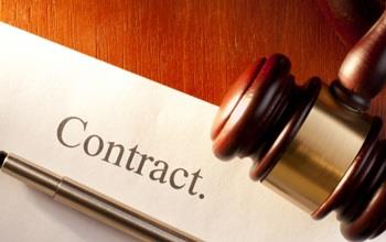 Pen and gavel on a contract.