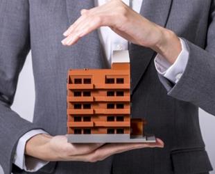 A man holding a model of an office building.