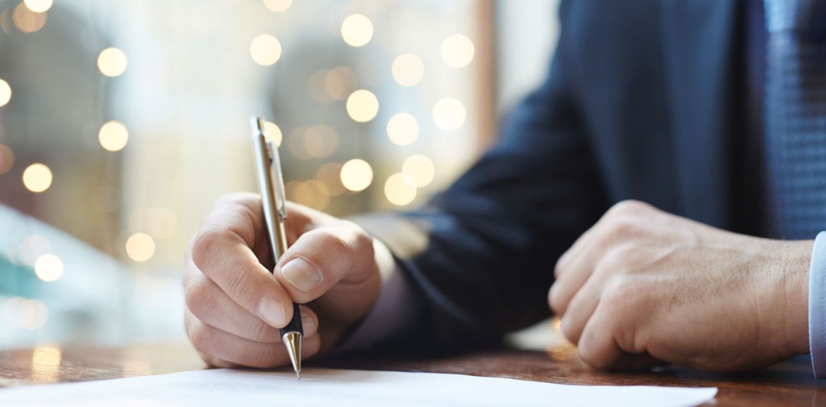 Closeup of a person's hand signing a document. Closeup of a person's hand signing a document.