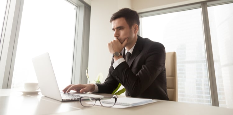 Man in an office with a laptop. Man in an office with a laptop.