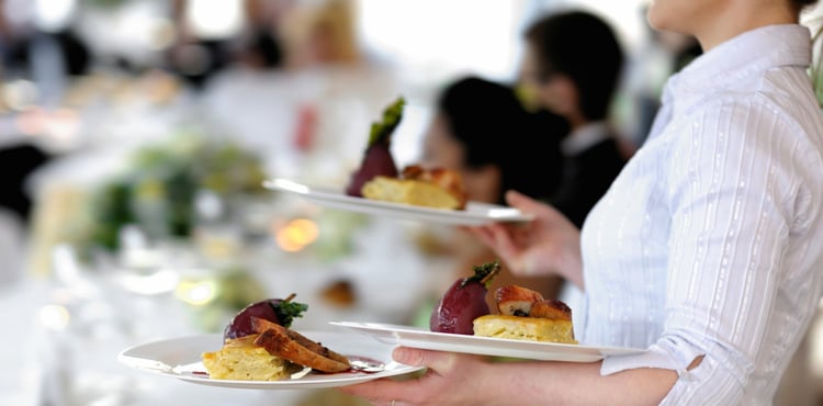 Waitress holding plates.