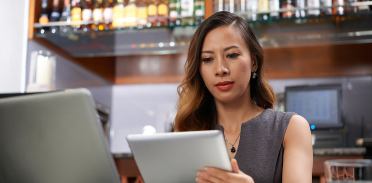 Woman working on iPad. Woman working on iPad.