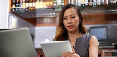 Woman working on iPad.