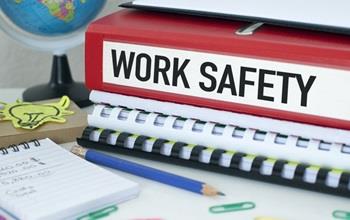 A work safety notebook on an office desk.