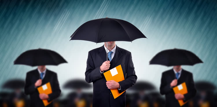 Businessmen carrying umbrellas during a storm