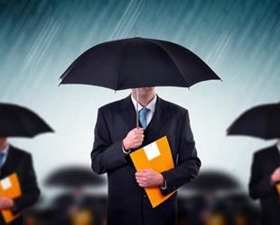 Businessmen carrying umbrellas during a storm