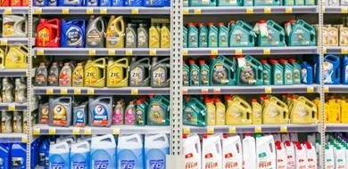 Detergent lined up on store shelves for sale.