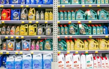 Detergent lined up on store shelves for sale.