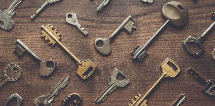 Keys placed on a wooden table in a pattern.