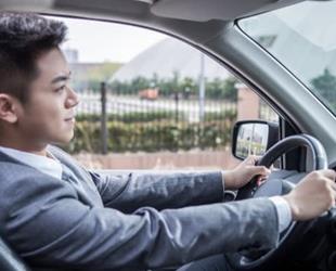 Man in a sport coat driving