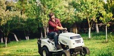 A man on a riding lawnmower
