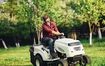 A man on a riding lawnmower