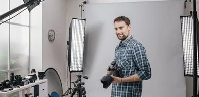 A professional photographer with cameras and equipment