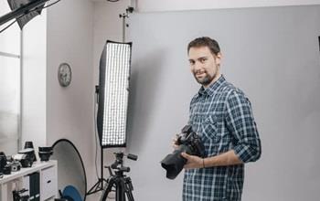 A professional photographer with cameras and equipment